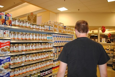 Man shopping in an aisle of a grocery store